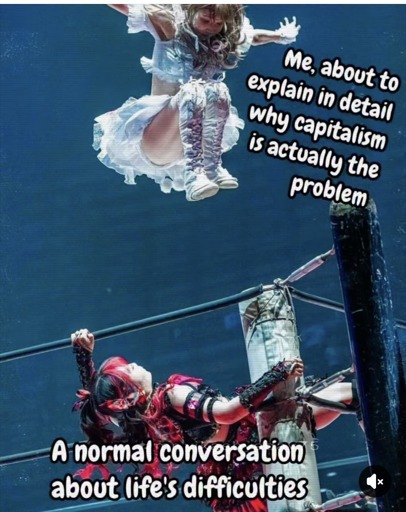A girl leaning on the ropes in a wrestling ring, wearing a red gothic lolita style dress, labeled "a normal conversation about life's difficulties" is being jumped on by a girl  in a similar white outfit labeled "me about to explain in detail why capitalism is actually the problem"