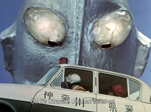 Picture of a robot's face up close, and a man in a car saying, "Ultraman saved us!"